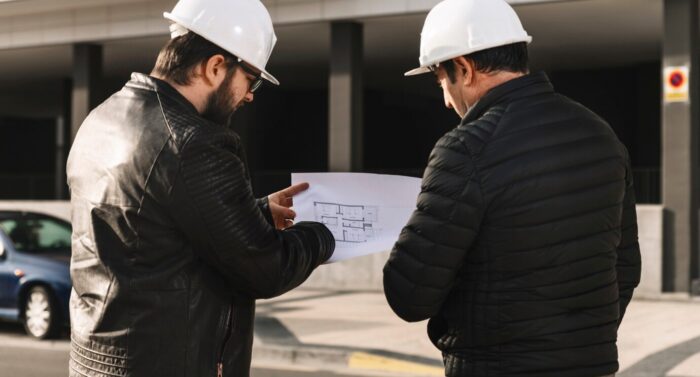 men-helmets-looking-plans_23-2147785486